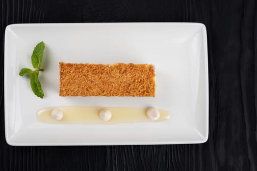 Esterhazy traditional cake with mint on black wooden background