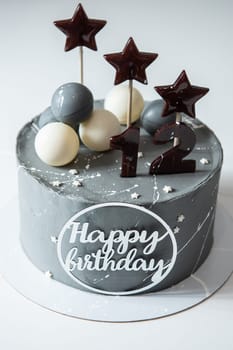 Birthday cake with decoration on white table. Twelve years birthday