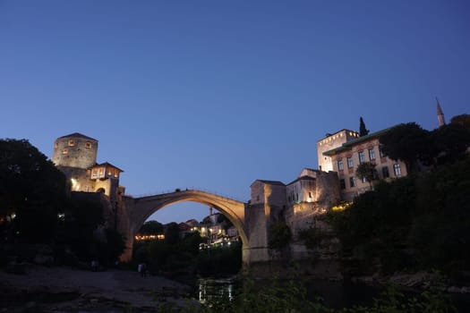Famous bridge of Mostar after sunset from below, 2020