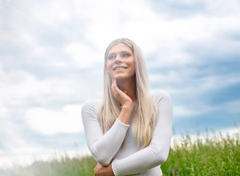 happy young blond girl on a meadow