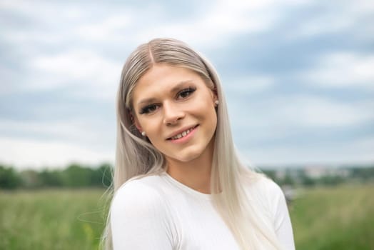 happy young blond girl on a meadow