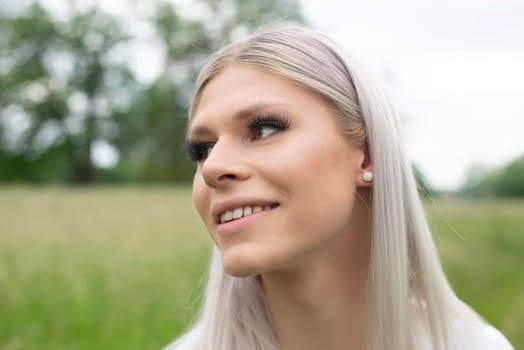 happy young blond girl on a meadow