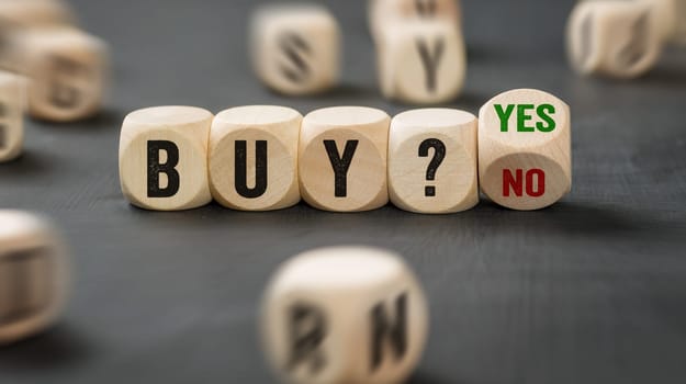 Letter dice with the word Buy Yes or No