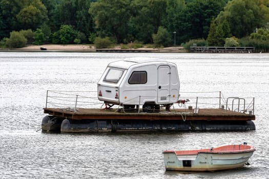 Camping trailer parked on the floating platform - Zarnowieckie Lake, Nadole, Pomerania, Poland