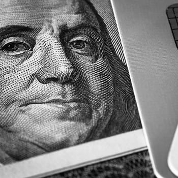 Benjamin Franklin's face on a hundred-dollar bill next to a credit card. Close-up. A hundred-dollar American bill with the eyes of Benjamin Franklin. Black and white style. Layout, template, layout.