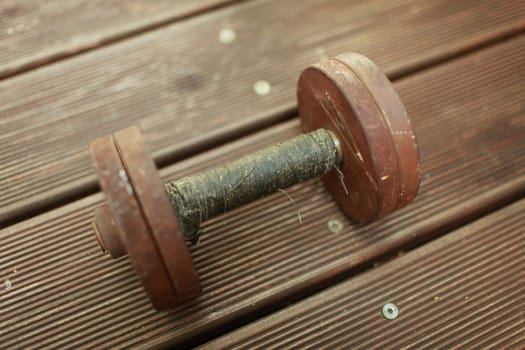 old heavy steel dumbbell, handle rewound with black duct tape close-up
