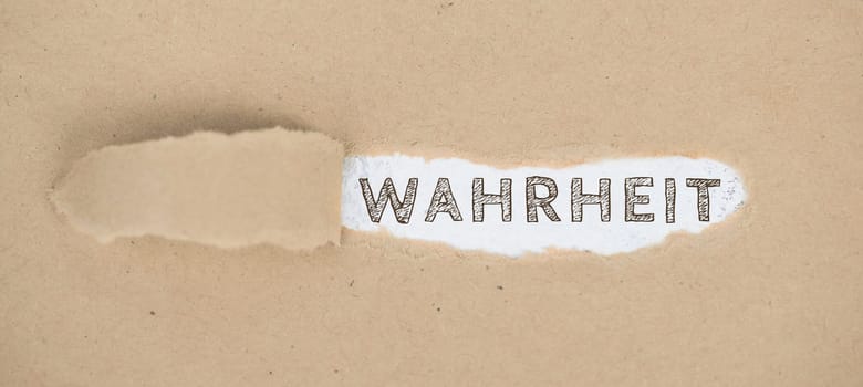 The words the truth standing on a ripped up paper