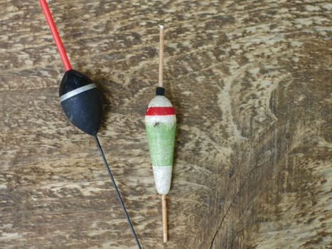 old fishing bobber on wooden texture still life