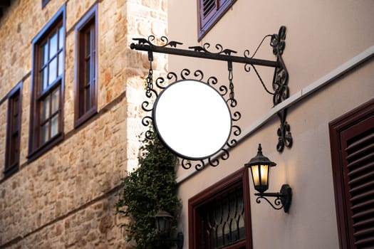 Horizontal front view of empty round signage on a building with classical rustic architecture