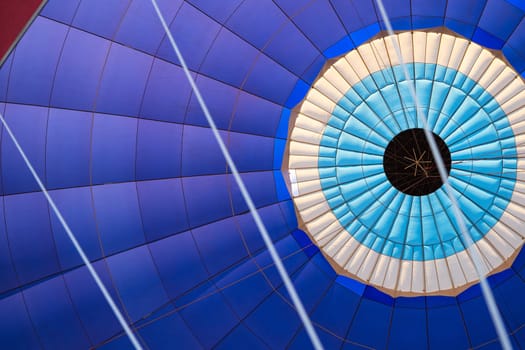 front view detail closeup of the colorful fabric interior texture of a hot air balloon during flight