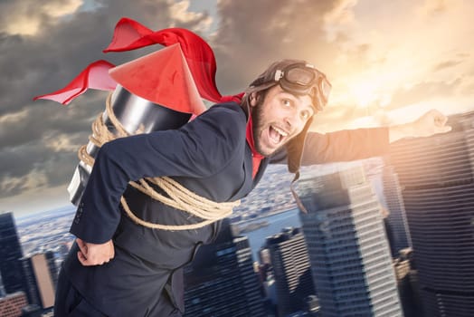 Businessman with homemade rocket and googles ready for a challenge