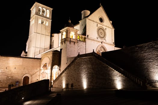Assisi Basilica by night in Umbria region, Italy. The town is famous for the most important Italian St. Francis Basilica (Basilica di San Francesco)