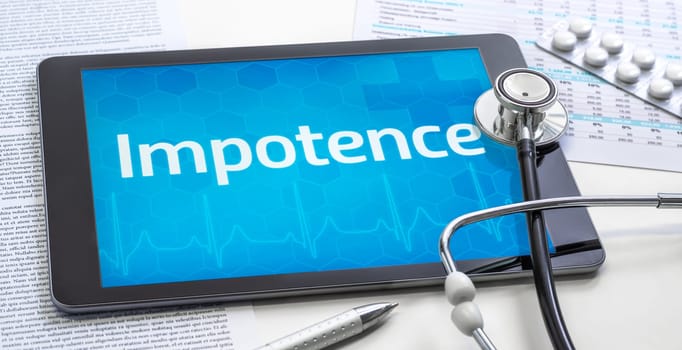 The word Impotence on the display of a tablet