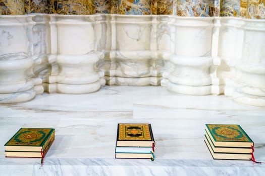 Sacred Quran books in an alcove at a mosque