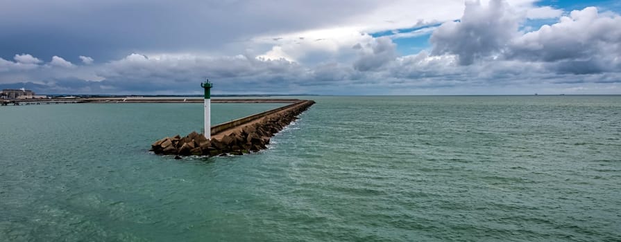 Breakwater with lighthouse on French coast - Calais, France