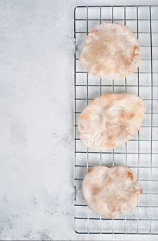 Fresh baked pita bread on a colling grid, empty copy space for text