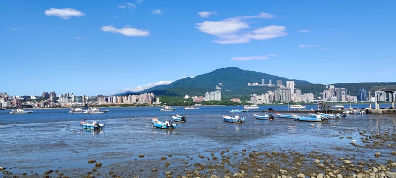 Tamsui, NEW TAIPEI CITY, TAIWAN - Sep 8, 2021 - City Tamsui Bali District in Taipei, Taiwan reflecting in the Tamsui River at nice day