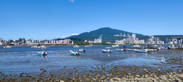 Tamsui, NEW TAIPEI CITY, TAIWAN - Sep 8, 2021 - City Tamsui Bali District in Taipei, Taiwan reflecting in the Tamsui River at nice day