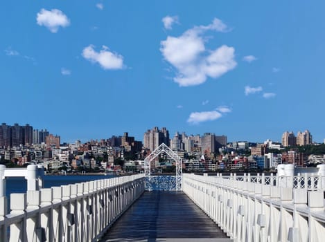 Tamsui, NEW TAIPEI CITY, TAIWAN - Sep 8, 2021 - City Tamsui Bali District in Taipei, Taiwan reflecting in the Tamsui River at nice day