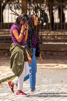AXUM, ETHIOPIA, APRIL 27th.2019: Ordinary carefree tigray native girls walking on the street in center of Aksum on April 27, 2019 in Aksum, Tigray, Ethiopia Africa