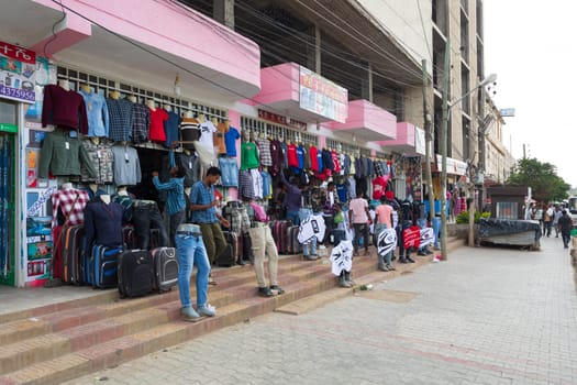AXUM, ETHIOPIA, APRIL 27th.2019: Tigray native people in market with clothes in center of Aksum on April 27, 2019 in Aksum, Tigray, Ethiopia Africa