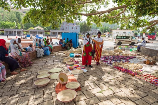 AXUM, ETHIOPIA, APRIL 27th.2019: Carefree tigray native woman resting in street market in center of Aksum on April 27, 2019 in Aksum, Tigray, Ethiopia Africa