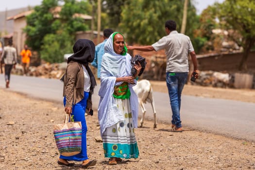 AXUM, ETHIOPIA, APRIL 27th.2019: Ordinary carefree tigray native woman walking on the street in center of Aksum on April 27, 2019 in Aksum, Tigray, Ethiopia Africa