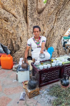 AXUM, ETHIOPIA, APRIL 27th.2019: Tigray native women prepare street bunna coffee under big tree in Central of Aksum on April 27, 2019 in Aksum, Ethiopia Africa