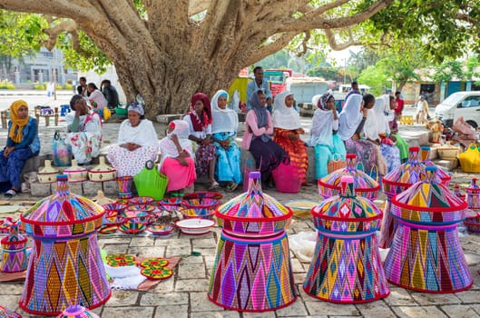 AXUM, ETHIOPIA, APRIL 27th.2019: Carefree tigray native woman resting in street market in center of Aksum on April 27, 2019 in Aksum, Tigray, Ethiopia Africa