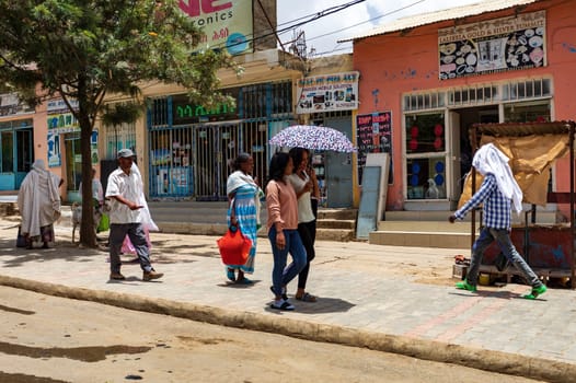 AXUM, ETHIOPIA, APRIL 27th.2019: Ordinary carefree tigray native woman walking on the street in center of Aksum on April 27, 2019 in Aksum, Tigray, Ethiopia Africa