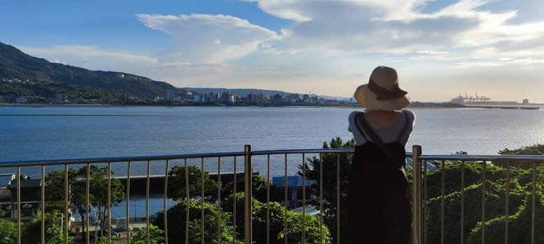 Tamsui, NEW TAIPEI CITY, TAIWAN - Sep 8, 2021 - City Tamsui Bali District in Taipei, Taiwan reflecting in the Tamsui River at nice day