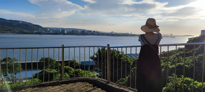Tamsui, NEW TAIPEI CITY, TAIWAN - Sep 8, 2021 - City Tamsui Bali District in Taipei, Taiwan reflecting in the Tamsui River at nice day