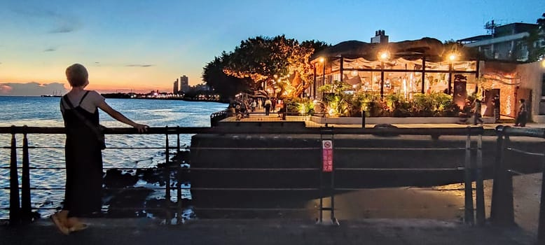 Tamsui, NEW TAIPEI CITY, TAIWAN - Sep 8, 2021 - City Tamsui Bali District in Taipei, Taiwan reflecting in the Tamsui River at nice day
