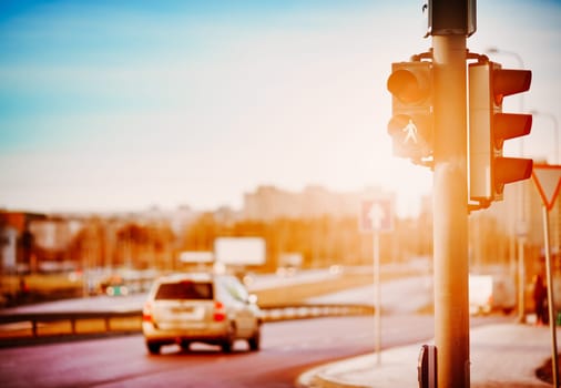 Crossroad with traffic light in the evening city. Concept of the road safety and transportation on the highway.
