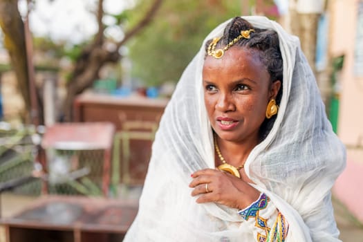 Mekelle, Ethiopia - April 28, 2019: Ethiopian beautiful woman with traditional costume on the street in Mekelle, second largest city and capital of Tigray region, in Ethiopia Africa