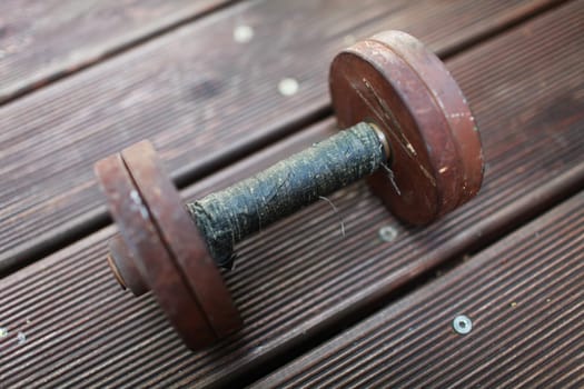 heavy steel dumbbell, handle rewound with black duct tape