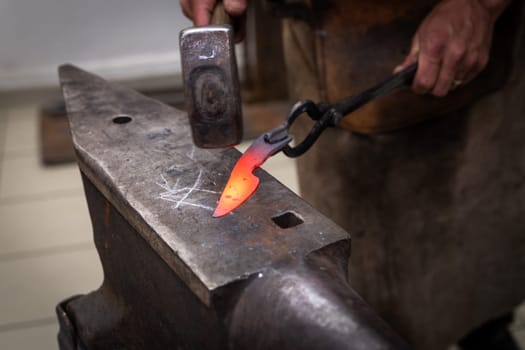 man hands are manufacturing a steel knife