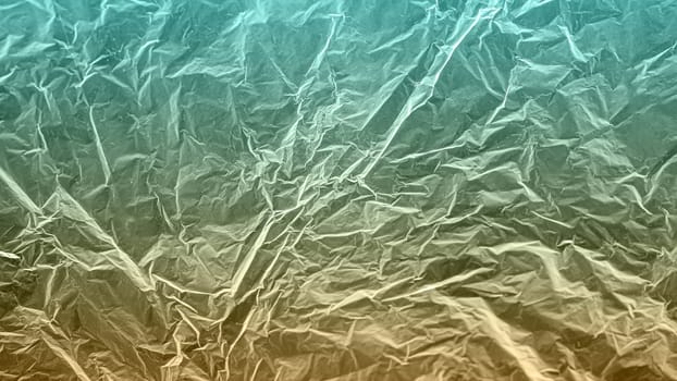 A textured blue and yellow gradient crumpled paper background with natural creases and folds. Ideal for design projects, digital graphics, or creative presentations requiring a vibrant.