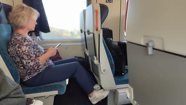 October 16 2024 Prague Czech Republic Europe Woman train phone windows travel tourism transport . High quality photo