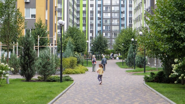 Apartment buildings in a new modern residential complex. Modern architecture. Social housing. The territory of a new residential area with tall buildings and large landscaping