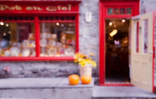 Blurred abstract image of window shop display or cafe with with opened door