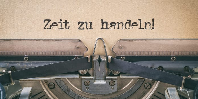 Text written with a vintage typewriter - Time to act in german - Zeit zu handeln