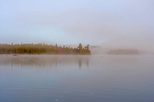 Morning Mist Slowly Clearing in the North Woods on Saganaga Lake in the Boundary Waters in Minnesota