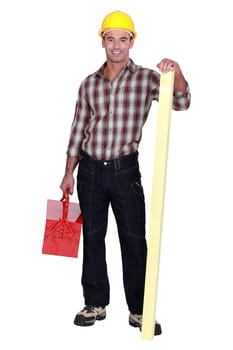 Confident carpenter standing on white background