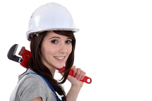 Woman resting wrench on shoulder
