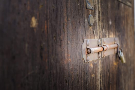 Old latch of a wooden door of a cow shed