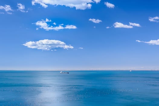 Marine scene with the ship and clouds