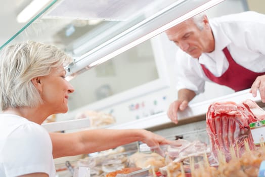 Butcher serving a customer