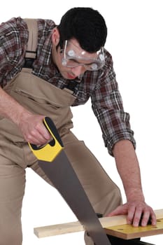 A carpenter sawing.