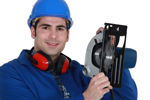 A manual worker with a circular saw.
